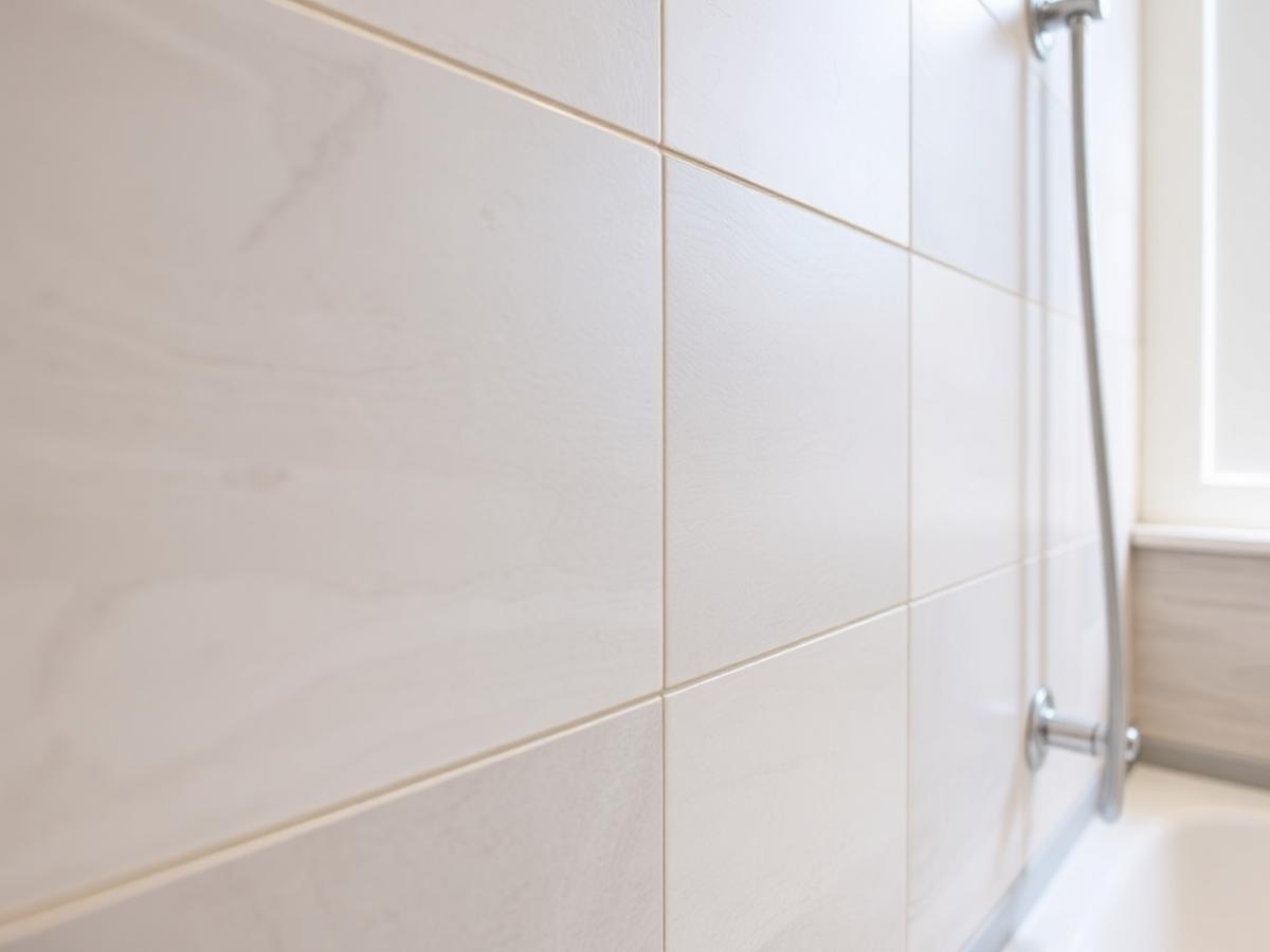 Close-up of neatly finished bathroom wall tiling